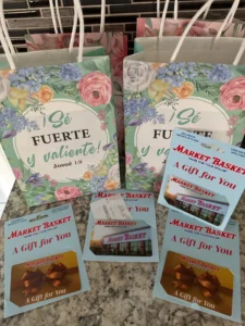 A collection of colorful Valentine's Day gift bags, featuring hearts and romantic designs, arranged on a table.